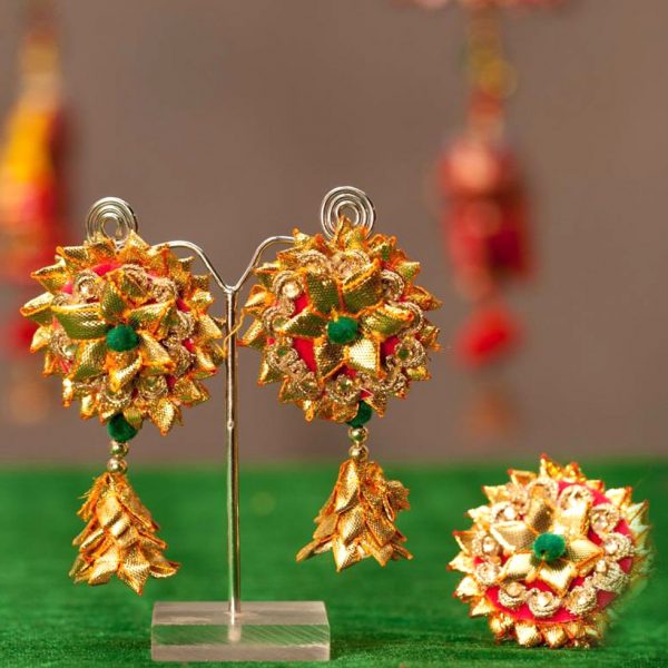 Fancy Designer Golden Earrings Jewelry With Newest Fashion Clicked On Red  Background Stock Photo  Download Image Now  iStock