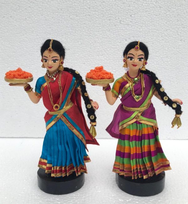 Girls holding plate of flower